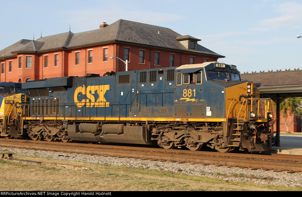 CSX 881 heads past the station